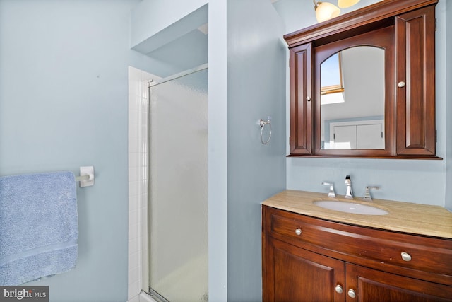 bathroom featuring vanity and a shower stall
