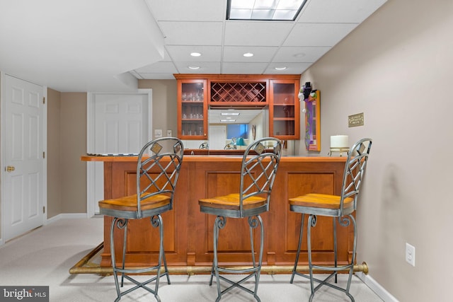 bar with a dry bar, carpet, recessed lighting, baseboards, and a drop ceiling