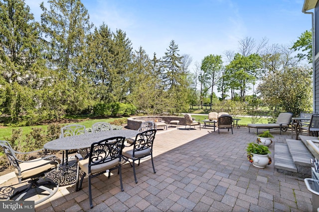 view of patio featuring outdoor dining space and a fire pit
