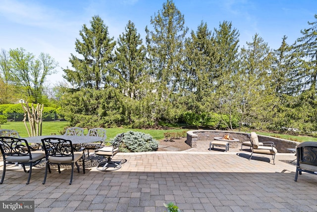 view of patio / terrace with outdoor dining area and a fire pit