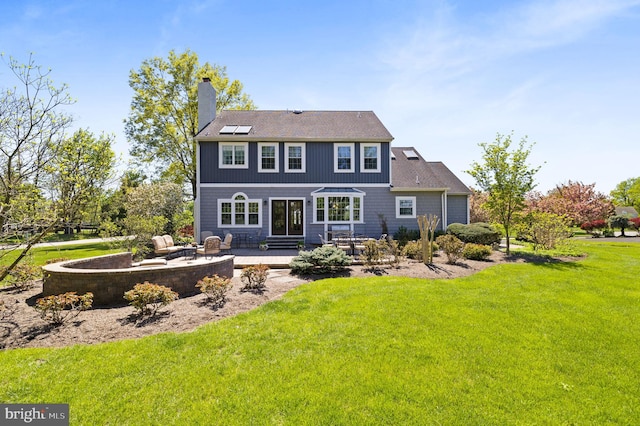 rear view of house with a lawn, a chimney, and a patio area