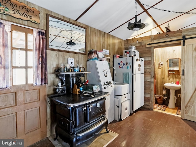 29 Roy Guinn Rd, Points, WV 25437 - kitchen featuring a barn door, wood finished floors, wooden walls, and a sink