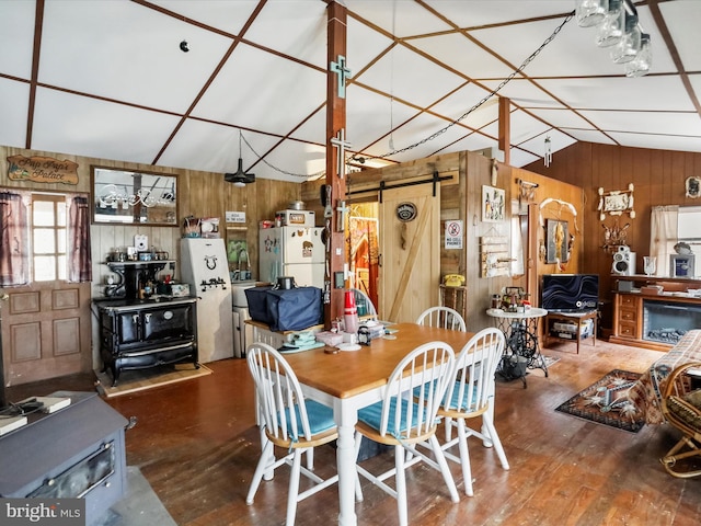29 Roy Guinn Rd, Points, WV 25437 - dining room featuring a barn door, lofted ceiling, wood finished floors, and wooden walls
