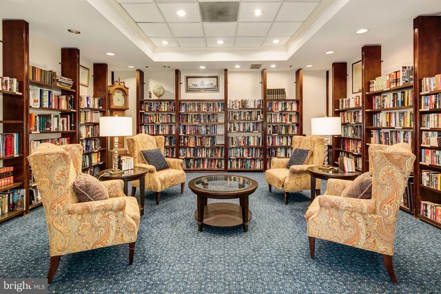 900 N Taylor St Unit 1811, Arlington, VA 22203 - living area featuring a tray ceiling, wall of books, and carpet floors
