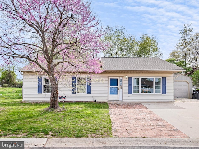 9 Honeysuckle Dr, Newark, DE 19702 - single story home with a front yard, a shingled roof, a garage, an outbuilding, and concrete driveway