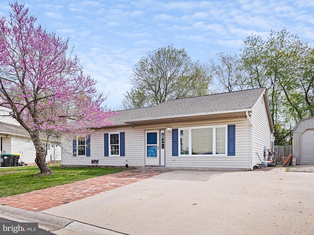 9 Honeysuckle Dr, Newark, DE 19702 - ranch-style house with roof with shingles, an outbuilding, concrete driveway, and a front yard