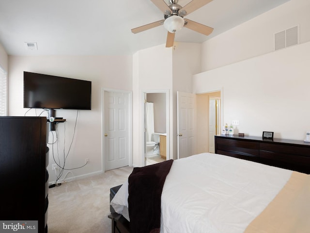 bedroom with connected bathroom, baseboards, visible vents, and carpet