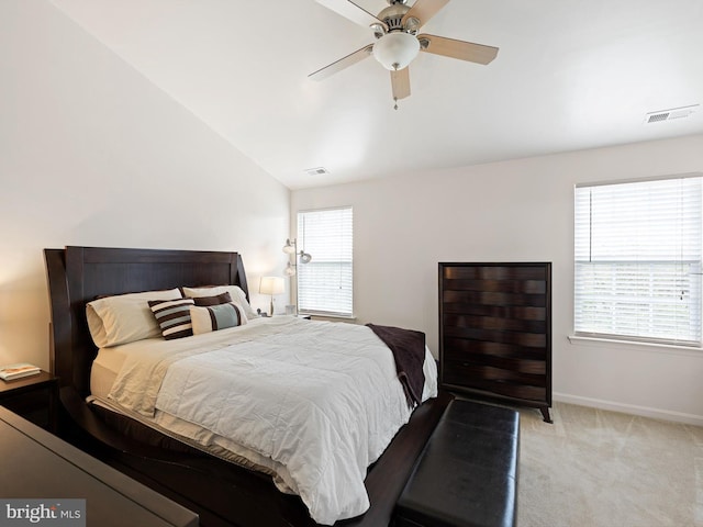 bedroom featuring vaulted ceiling, baseboards, visible vents, carpet, and ceiling fan