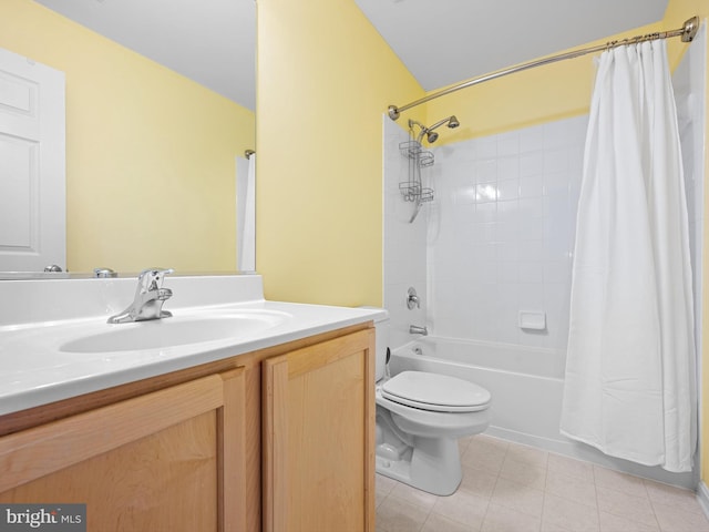full bathroom with tile patterned floors, shower / bath combo with shower curtain, vanity, and toilet