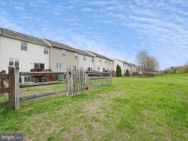 view of yard featuring fence and a residential view