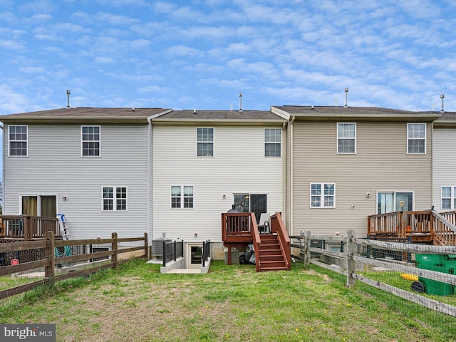 rear view of house featuring central AC, a lawn, a deck, a fenced backyard, and stairs