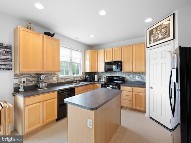 kitchen with dark countertops, light brown cabinetry, a sink, and black appliances