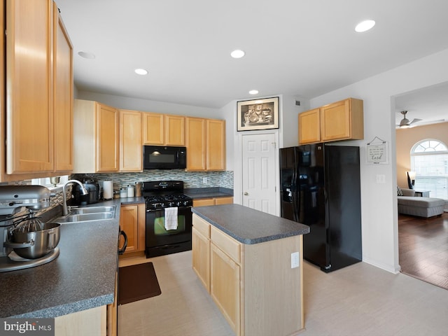 kitchen featuring dark countertops, light brown cabinets, a sink, and black appliances