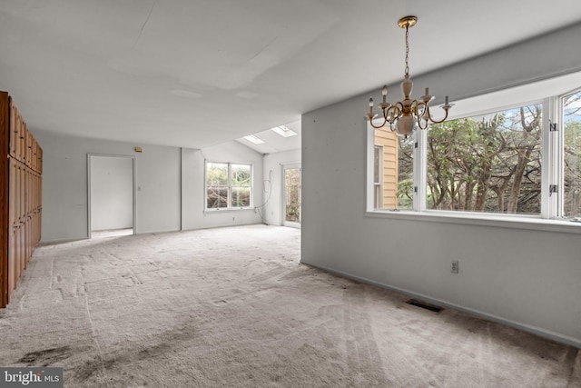 29 Foxcroft Dr, Princeton, NJ 08540 - unfurnished dining area featuring visible vents, carpet, vaulted ceiling with skylight, and an inviting chandelier