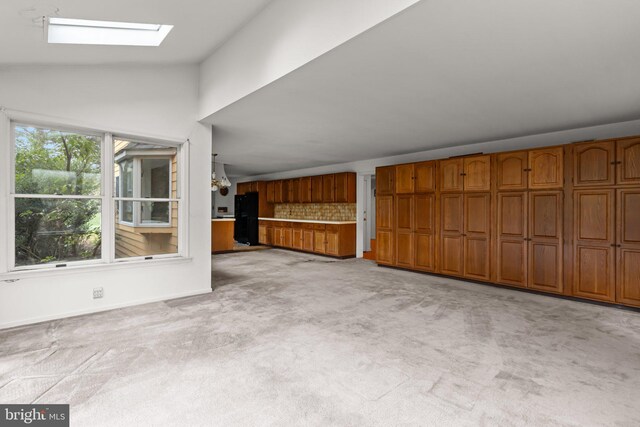 29 Foxcroft Dr, Princeton, NJ 08540 - unfurnished living room with light carpet, vaulted ceiling with skylight, and baseboards