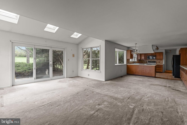 29 Foxcroft Dr, Princeton, NJ 08540 - unfurnished living room with baseboards, light colored carpet, an inviting chandelier, and lofted ceiling with skylight