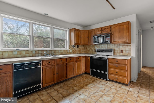 29 Foxcroft Dr, Princeton, NJ 08540 - kitchen with tile countertops, black appliances, a sink, brown cabinets, and backsplash