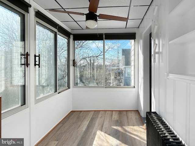 unfurnished sunroom with radiator and healthy amount of natural light