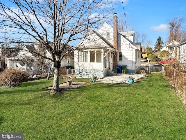 rear view of house with a chimney and a patio