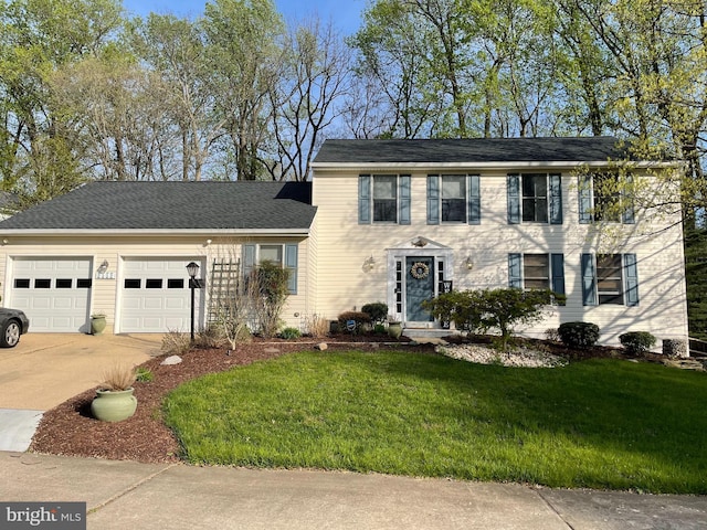 colonial house with a garage, concrete driveway, and a front yard