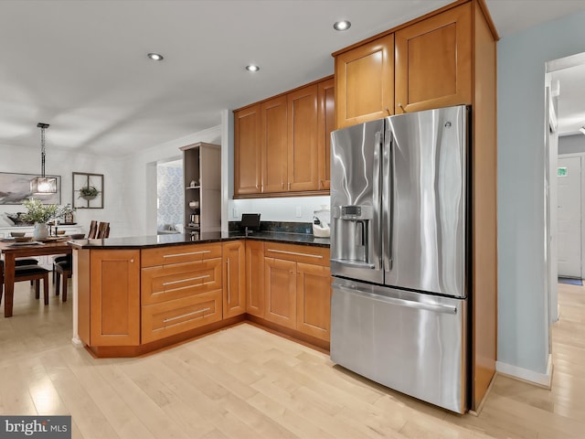 kitchen featuring stainless steel fridge with ice dispenser, light wood-style flooring, brown cabinetry, and recessed lighting