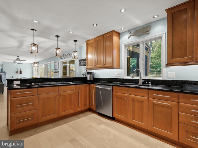 kitchen with dishwasher, brown cabinetry, a peninsula, dark stone countertops, and a sink