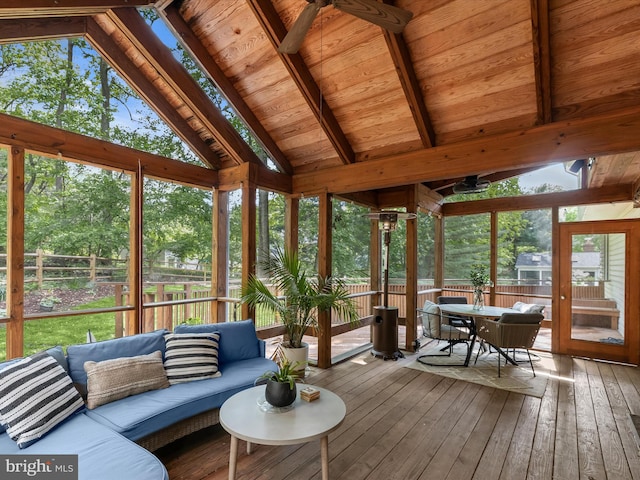 sunroom with an outdoor living space, outdoor dining area, plenty of natural light, and a ceiling fan