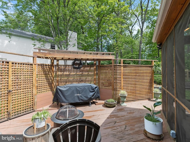 deck with a grill and a fire pit