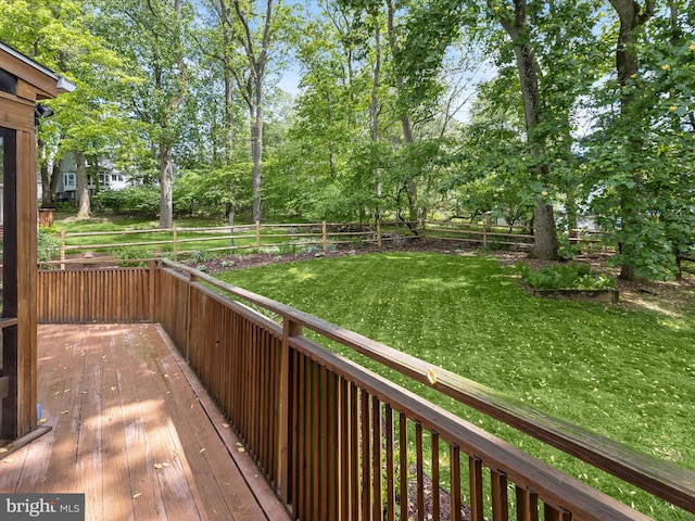 wooden terrace with view of wooded area