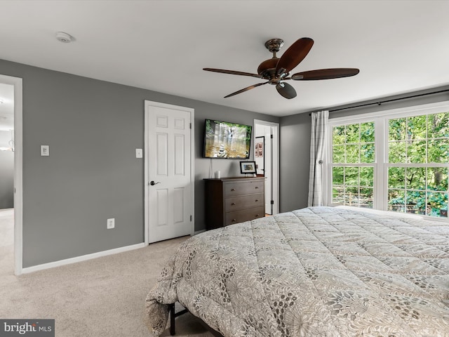 bedroom with carpet flooring, baseboards, and a ceiling fan