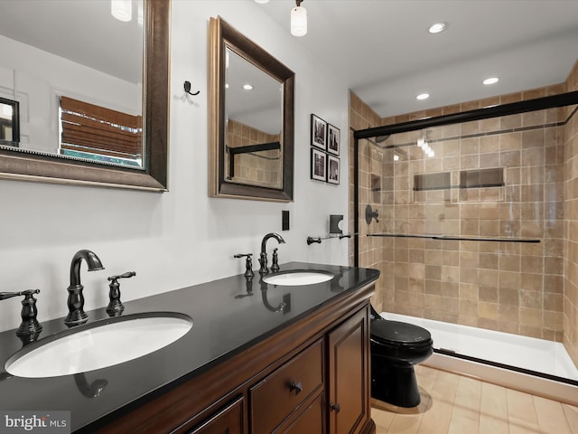 full bathroom featuring a shower stall, toilet, double vanity, and recessed lighting