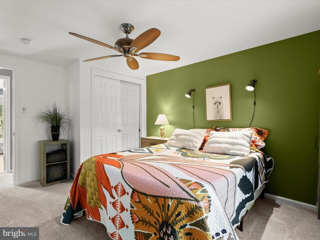 bedroom featuring carpet, a closet, a ceiling fan, and baseboards