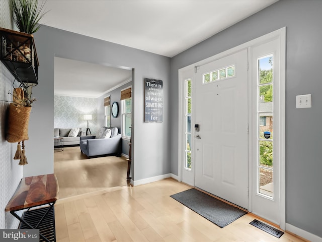 foyer entrance featuring wood finished floors and baseboards