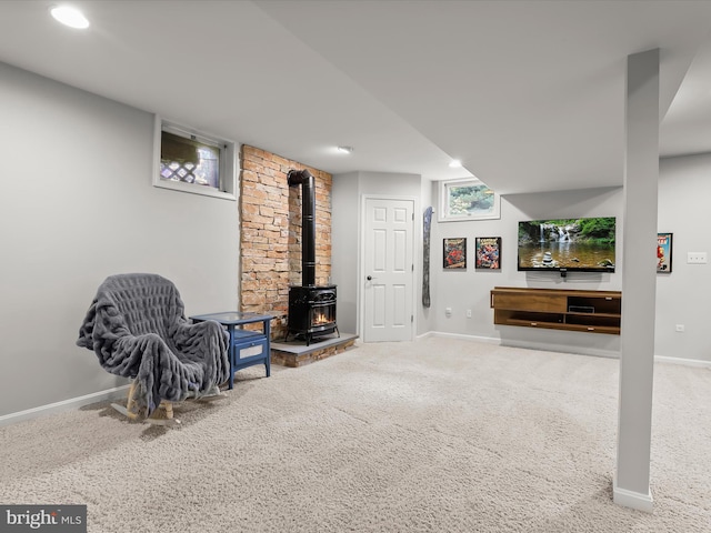 living area with a wood stove, carpet, baseboards, and recessed lighting