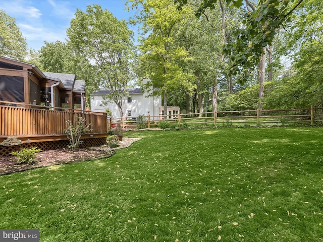 view of yard with a deck and a sunroom