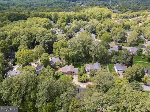 aerial perspective of suburban area with a heavily wooded area