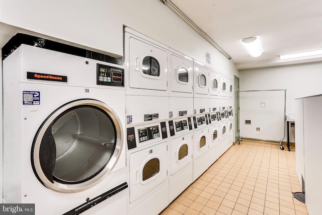 common laundry area featuring stacked washer and clothes dryer, independent washer and dryer, and light tile patterned floors