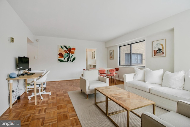 living area featuring baseboards
