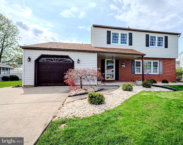 traditional home featuring concrete driveway, a front yard, brick siding, and an attached garage