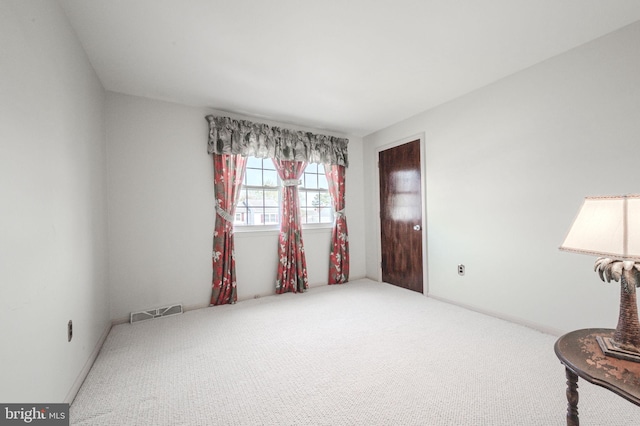 interior space featuring visible vents and carpet floors