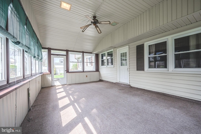 unfurnished sunroom featuring a wealth of natural light and a ceiling fan
