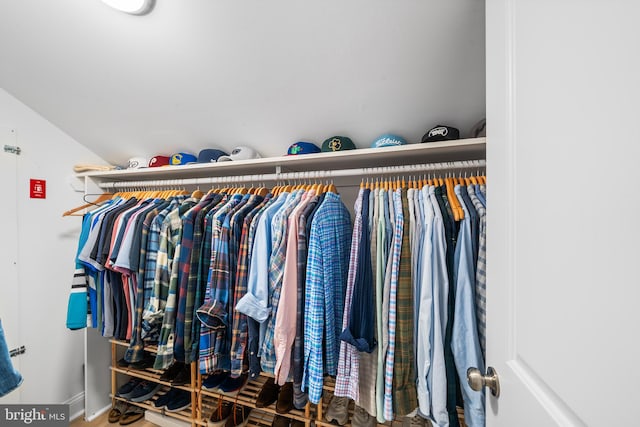 walk in closet with lofted ceiling