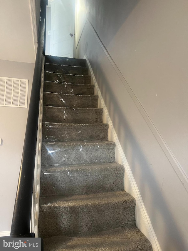 staircase featuring visible vents