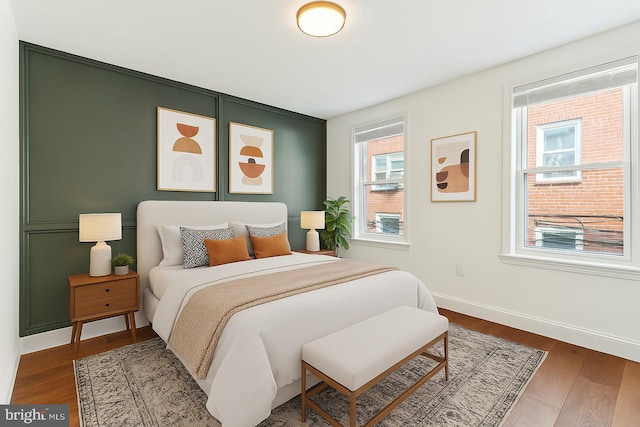 bedroom with baseboards and wood finished floors