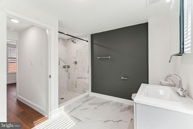 bathroom with visible vents, baseboards, a shower stall, and vanity