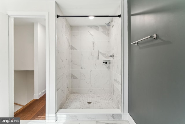 full bath with baseboards and a stall shower