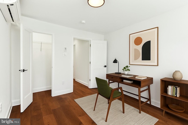 home office featuring baseboards, wood finished floors, and a wall mounted air conditioner