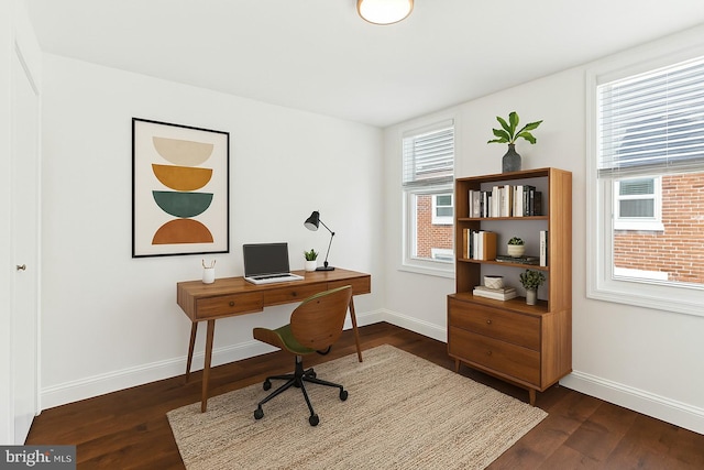 office space featuring baseboards and dark wood finished floors