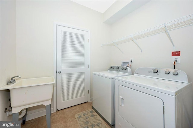 laundry area featuring light tile patterned floors, independent washer and dryer, and laundry area