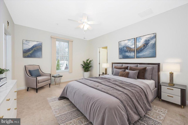 bedroom with light carpet, ceiling fan, and baseboards